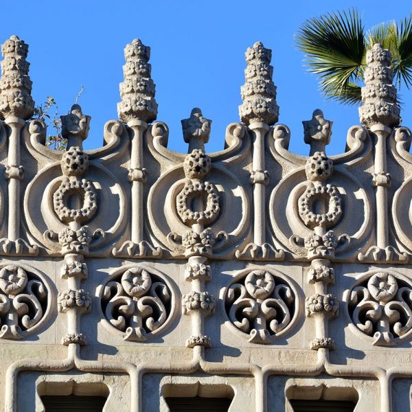 Barcelona.- Casa Lleó Morera de 1905 de Lluis Domènech i Montaner - Remat de l’edifici amb pinacles mitges columnes i medallons decorats amb motius florals (2/2015)