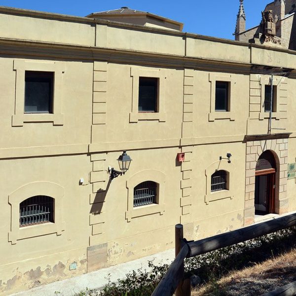 Montblanc.- Centre d’Interpretació de l’Art Rupestre, edifici neoclàssic que era l’antiga presó amb un escut dalt de la façana al·lusiva a la Justícia (4/2014)