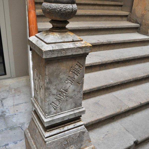 Tarragona.- Casa d’en Tomàs Brull. Pilar de la barana de l’escala rematat per un aglà de pedra i les inscripcions “Alabat Sia Deu” i la data “1900” (7/2012)